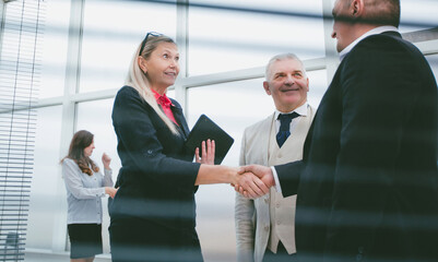 Poster - through the blinds. successful business partners meeting each other with a handshake