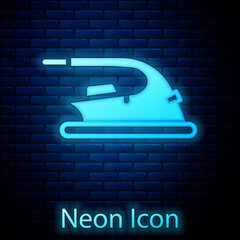 Sticker - Glowing neon Electric iron icon isolated on brick wall background. Steam iron. Vector