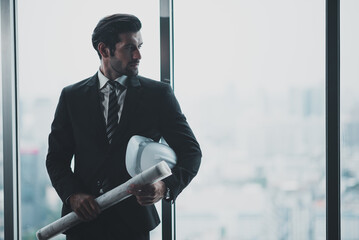 Wall Mural - The handsome male architect has a leadership role in the work.Business man standing confidently looking at architecture.Business executives have a leadership concept.