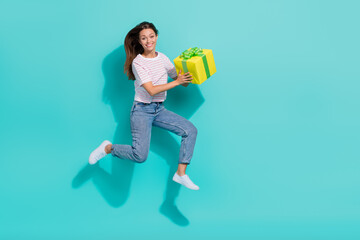 Sticker - Full length photo of positive nice girl with long hairstyle striped t-shirt hold yellow gift box isolated on turquoise color background