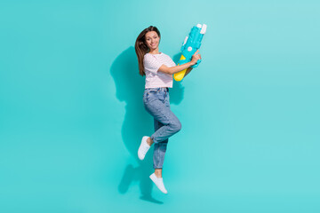 Canvas Print - Full size photo of positive woman with straight hairstyle wear striped t-shirt hold water gun jumping isolated on teal color background