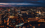 Fototapeta Miasto - Aerial view of north east part of London, in evening. St Pauls Cathedral visible over river Thames
