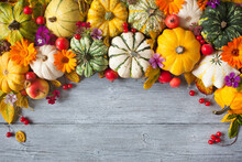 Wooden Background With Pumpkins, Fruits, Flowers, Plants, Leaves, Apples, Viburnum Berries, Rosehips. Autumn Holiday Card, Halloween, Thanksgiving, Top View, Copy Space.