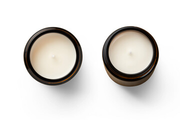 two unused white hand-poured soy wax scented candles in brown glass jars - isolated design elements for cozy or holiday scenes as well as self care themed designs, top view / flat lay