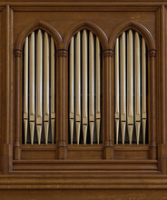 Church Organ Pipes Through A Wood Panel
