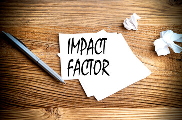 Poster - IMPACT FACTOR text written on sticky on wooden background