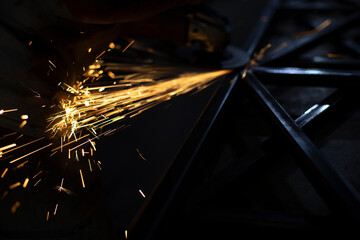 Sparks from steel. Metal sawing. Lights in dark. Work in garage.