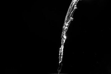 Poster - water splashes isolated on black background. white jets with drops