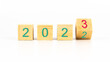 © Mete Caner Arican - 2023 new year concept with wooden cubes on white background. Entering to 2023 new year concept idea. Changing year from 2022 to 2023 with wooden cubes