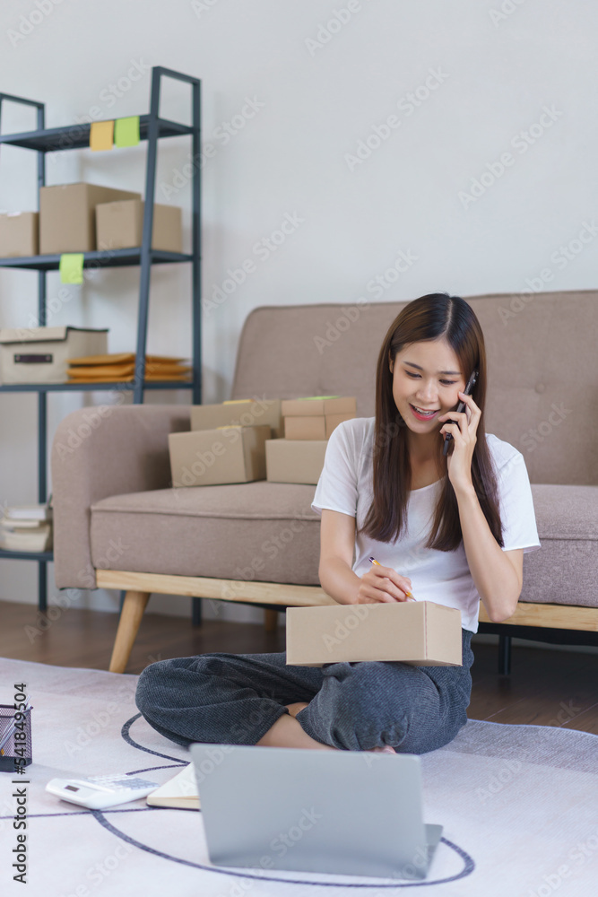 Online business concept, Asian business woman talks on smartphone and ...