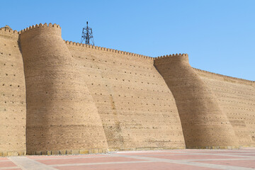 Wall Mural - Fragment of the fortress wall with two towers of the ancient Ark fortress on a sunny day. Bukhara, Uzbekistan