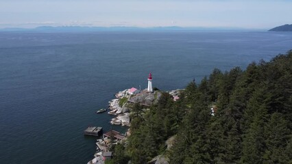 Poster - Aerial shot of lighthouse on a rocky seashore and deep blue sea in Lighthouse Park, Vancouver Canada