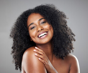 Wall Mural - Face, beauty and skincare with a model black woman in studio on a gray background with a happy smile. Portrait, cosmetics and wellness with an attractive young female posing to promote a product