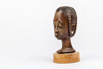 Wooden figurine of an African woman isolated on white background, left view	