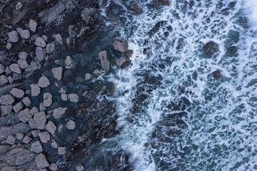 Wall Mural - Aerial drone landscape bird's eye view of vibrant sunset over Welcombe Mouth Beach in Devon England with waves crashing on rocks