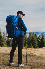 Wall Mural - a man with a large tourist backpack on the background of mountains landscape tourism travel recreation hiking truancy trekking creations beauty of nature autumn in the mountains of the Carpathians