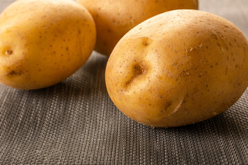 Wall Mural - bunch of potatoes close up on wooden board