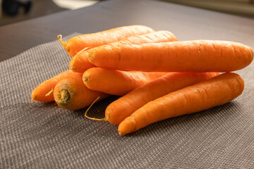 Wall Mural - bunch of carrots close up in wooden board