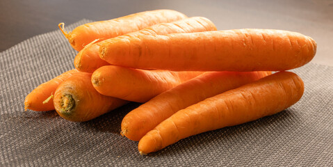 Wall Mural - bunch of carrots close up in wooden board