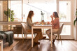 © Austockphoto - Female same sex couple eating a meal together at home