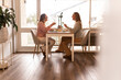 © Austockphoto - Female same sex couple eating a meal together at home