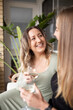 © Austockphoto - Happy same sex couple looking at each other while holding a glass of wine on outdoor couch
