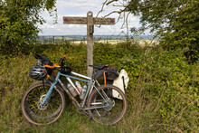 Pair Of Cross Country Bikes With Bags Against A South Downs Way Sign