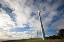 Wind Turbines On A Bare Grassy Hill Exposed To Offshore Winds On The Fleurieu Peninsula