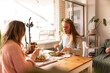 © Austockphoto - Female same sex couple eating a meal together at home
