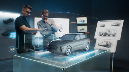 Two development engineers in the studio are designing an eco-friendly sustainable standard electric vehicle using 3D modeling technology and VR headsset. 3D interface of diagnostic application.
