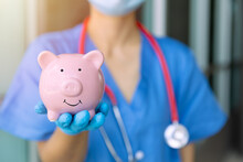 Medical Staff Hand Showing Piggy Bank Smile For Saving Money For Future Healthcare Health Insurance Concept
