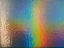 High Res Full Frame Macro Photo Of Abstract Pastel Iridescent Holographic Foil Background With Light Leaks. Holo Color Wrinkled Material. Cool Glitter Surface With Shiny Rainbow Feel. 