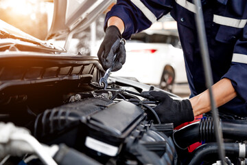 Car care maintenance and servicing, Close-up hand technician auto mechanic using the wrench to repairing change spare part car engine problem and insurance service support.