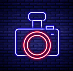 Sticker - Glowing neon line Photo camera icon isolated on brick wall background. Foto camera. Digital photography. Colorful outline concept. Vector