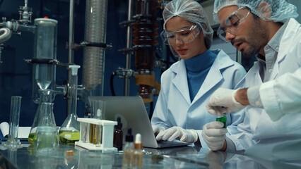 Two scientist in professional uniform working in laboratory for chemical and biomedical experiment