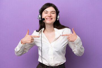 Telemarketer Russian woman working with a headset isolated on purple background proud and self-satisfied