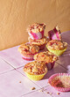 © Jennifer Causey - Raspberry muffins with crumble topping on pink tile with orange wall
