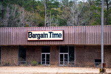 Old Delapidated Abandoned Shopping Strip Mall With Bargain Time Store Closed Or Bankrupt In Suburb Small Rural City Of Jack, Alabama