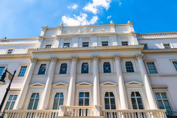 Looking up view of Belgrave square in Belgravia, London United Kingdom street with old historic Georgian architecture of terraced house