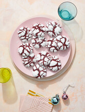 Chocolate Crinkle Cookies On Pink Plate With Ornaments
