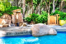 Hot Tub Pool With Japanese Garden Onsen Hot Springs Waterfall With Green Plants In Summer By Wooden Bamboo Fence, Rocks And Stones In Japan