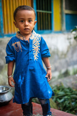 Portrait of a south asian toddler wearing traditional blue coloured dress