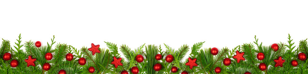 Wall Mural - Winter bottom border with evergreen branches and red Christmas decorations. Top view isolated on a white banner background.