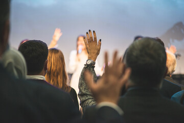 Wall Mural - Hands in the air of people who praise God at church service