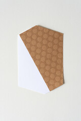 Wall Mural - brown paper with dot pattern and white paper object isolated on blank paper