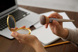 © New Africa - Woman with cosmetic pocket mirror and makeup brush at wooden table indoors, closeup