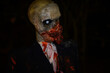 Horror zombie dummy as Halloween decoration in darkness