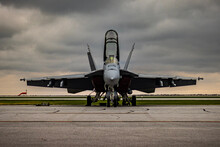 Jet Fighter On The Tarmac With Storm Clouds Approaching