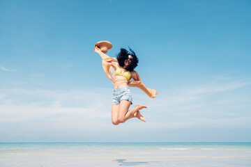 Happy girl jumping on the beach, Beach summer holiday sea people concept