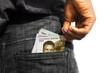 Black man putting few Nigerian naira notes into his back pocket. Removing money from pocket, hold money
